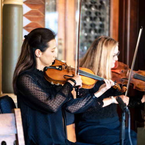 San Jose Symphony members playing violin in the grand ballroom